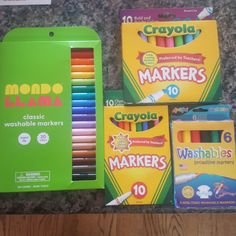 crayons and markers are sitting on the counter next to each other in boxes