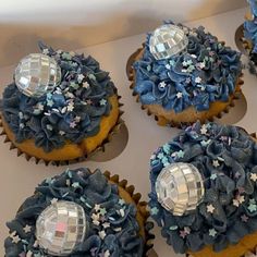 several cupcakes with blue frosting and stars on them