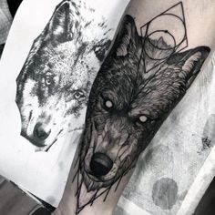 two wolf tattoos on the arm