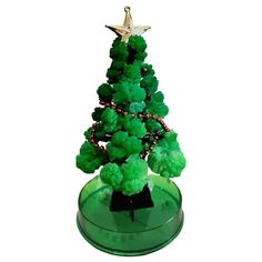 a small green christmas tree sitting on top of a table