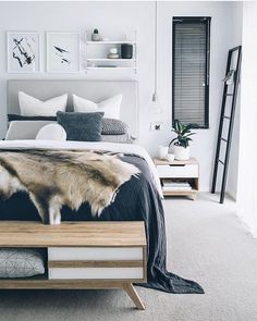 a bedroom with white walls and carpeted flooring is decorated in black and white