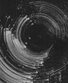 an abstract black and white photo with many lines in the center that appear to be swirling