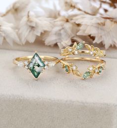 three rings with green and white stones on them