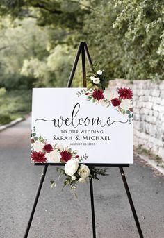 a welcome sign with flowers on it