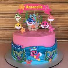 there is a cake decorated with different types of animals on it, and the words anttenella written in large letters