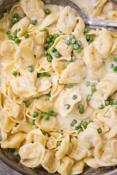 a skillet filled with pasta and peas