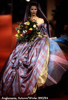 Over the years tartan has become synonymous with the Vivienne Westwood name, conjuring up images of vibrant plaid suits, classic tartan accessories, and Vivienne’s very own clan; the McAndreas. Famed for her love of traditional British fabrics, Vivienne’s use of tartan in particular exploded onto the catwalk with the Autumn/Winter 1993/94 collection, Anglomania. This iconic collection saw supermodels Linda Evangelista, Christy Turlington, Naomi Campbell and Kate Moss hit the red-car... Tartan Wedding Dress, Vivien Westwood, Viviane Westwood, Vivienne Westwood Wedding Dress, Fashion Vivienne Westwood, Vivienne Westwood Wedding, Punk Mode, Tartan Wedding