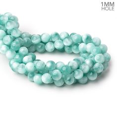 a strand of light blue glass beads on a white background