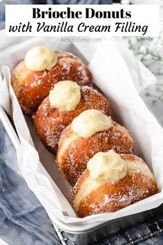 three vanilla cream filled doughnuts in a white paper container with text overlay