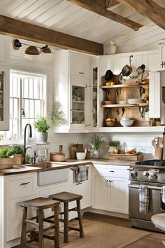 a kitchen filled with lots of white cabinets and counter tops covered in pots and pans