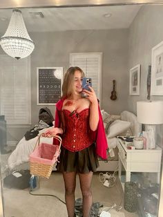 a woman in a red corset taking a selfie with her cell phone