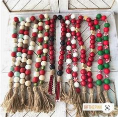 christmas wooden bead garlands with tassels and candy canes on them