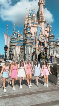 the girls are posing in front of the castle