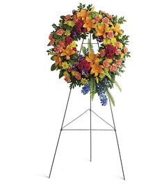 a standing wreath with flowers and greenery