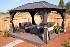 a gazebo sitting in the middle of a yard