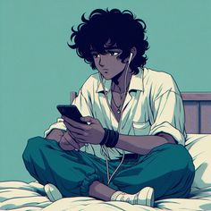 a man sitting on top of a bed holding a cell phone and listening to headphones