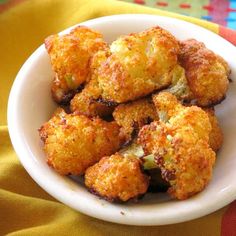 a white bowl filled with fried cauliflower bites