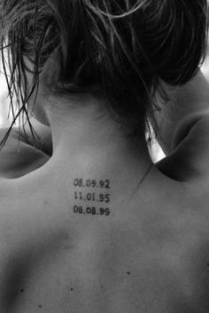 the back of a woman's neck with numbers on it