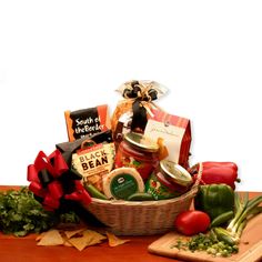 a basket filled with lots of food sitting on top of a wooden table