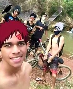 a group of young men standing next to each other in front of a body of water