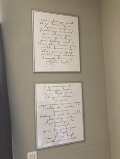 two framed pictures with writing on the wall