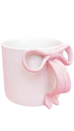 a pink coffee cup with an elephant shaped handle