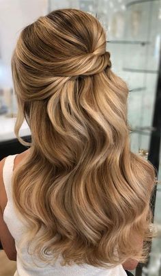 a woman with long blonde hair in a half updo