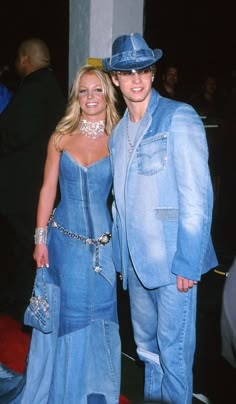 a man and woman dressed in blue clothes