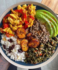 a blue plate topped with rice, beans and veggies next to an avocado