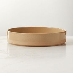 a brown bowl sitting on top of a white counter