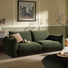 a living room with a green couch and coffee table