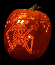 a carved pumpkin with a skeleton on it