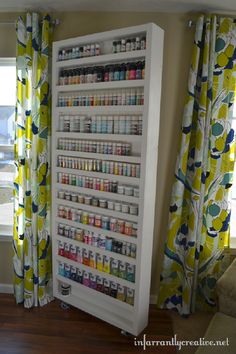 a white cabinet filled with lots of bottles