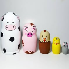 five different colored toy animals sitting next to each other