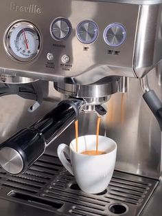 espresso machine with coffee being poured into cup