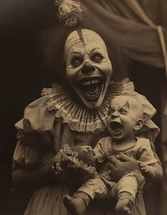 an old photo of a creepy clown holding a crying baby in his arms and laughing