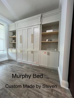 an empty room with white cabinets and wood flooring in the middle, along with text that reads murphy bed custom made by steve