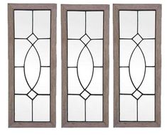 three stained glass windows with wood frames on each side and one window in the middle