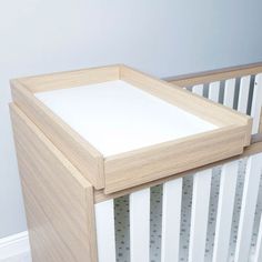 a wooden crib with white paint on it