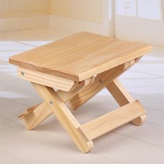 a small wooden table sitting on top of a white floor