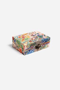 a colorful box with an intricate design on the lid and bottom, sitting against a white background