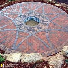 a circular brick fire pit surrounded by rocks