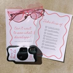 a pair of pink glasses sitting on top of a table next to a paper with the words take pieces of