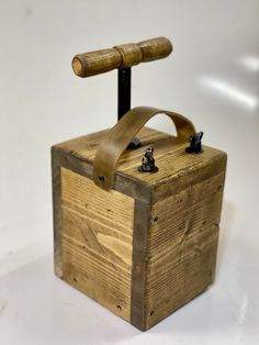 a wooden box with a handle on it