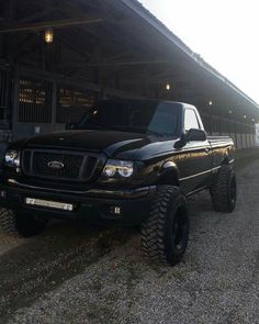 a black truck parked in front of a building