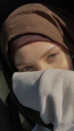 a close up of a person wearing a head covering