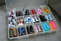 an open white box filled with lots of different types of shoes and other items in it