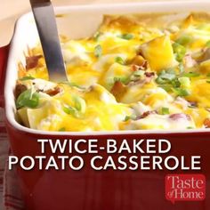 a red casserole dish with green onions and cheese