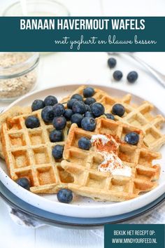 a plate with waffles and blueberries on it