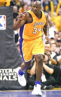 a basketball player running on the court with his foot in the air and people watching